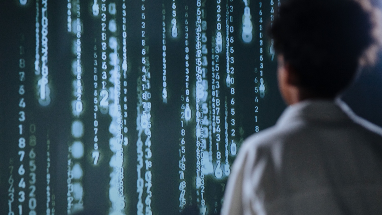 Person viewing streams of digital data representing artificial intelligence and frontier AI systems